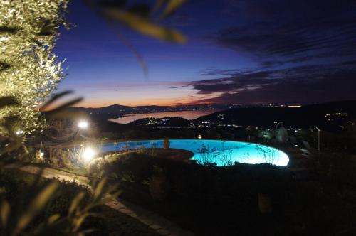 a view of a swimming pool at night at EcoResort Il Cantico della Natura in Magione