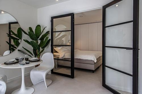 a bedroom with a table and a bed and a mirror at Cloud Nine - romantic & design app in city center! in Dordrecht