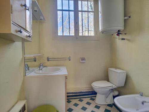 a bathroom with a toilet and a sink and a window at Maison Jullouville, 3 pièces, 4 personnes - FR-1-361-69 in Jullouville-les-Pins
