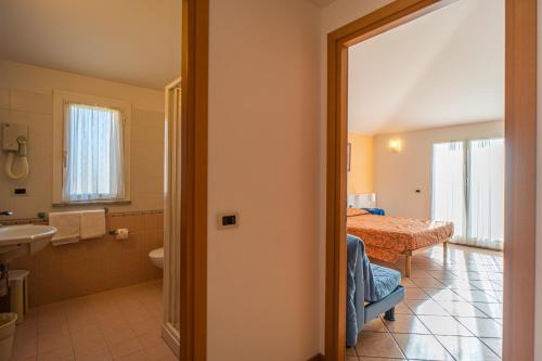 a room with a bathroom with a bed and a sink at Residence Villa Gloria in Borgio Verezzi