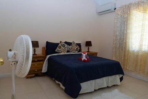 a bedroom with a bed with a teddy bear on it at Smart villa @ Richmond in Richmond