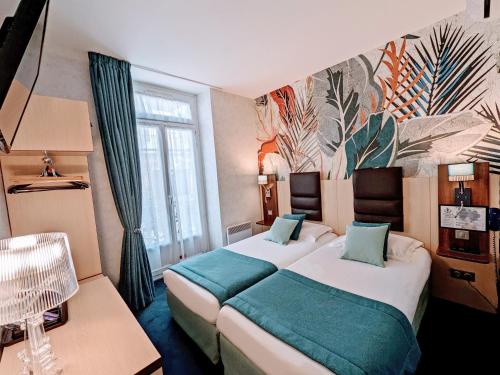 a hotel room with two beds and a mural at HOTEL ARVERNA VICHY - ClT'HOTEL in Vichy