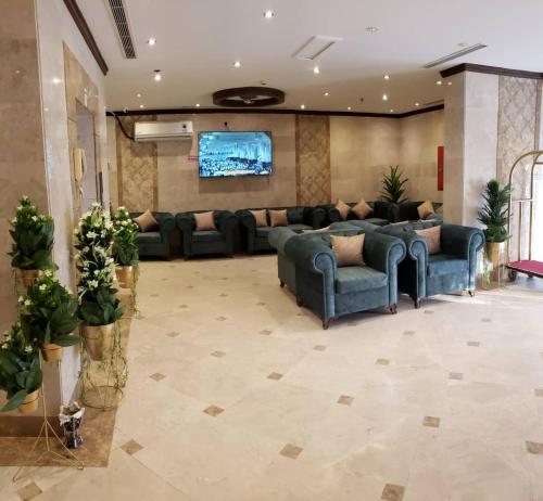 a large living room with couches and a flat screen tv at ضيف المشاعر in Makkah