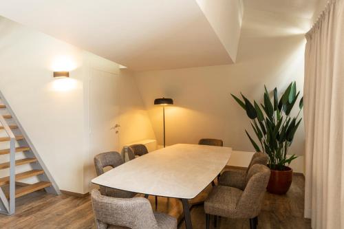 a dining room with a table and chairs at Dukes' Apartments Grand Place - by Dukes' Hotel Collection in Bruges
