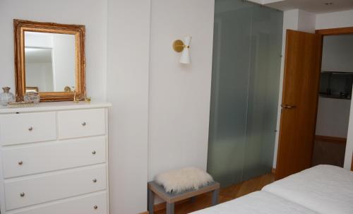 a bedroom with a dresser and a mirror at La Placita de Ana en Pontevedra centro in Pontevedra