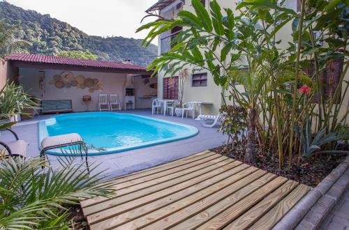 a swimming pool in the backyard of a house at Pousada Castelinho in São Sebastião