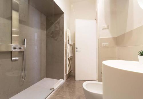 a bathroom with a shower and a sink and a toilet at Flat with whirlpool bath in the historic centre in Perugia