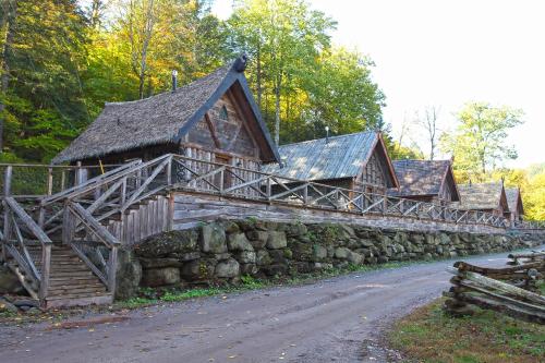 a building with a stone wall next to a road at Vikings Villages Resort in Guilford