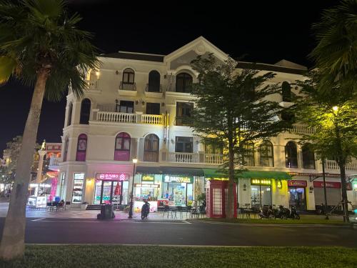 a building on a city street at night at B&K Homestay - Glocery Store in Phu Quoc