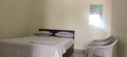 A bed or beds in a room at Family Guest House Pondicherry