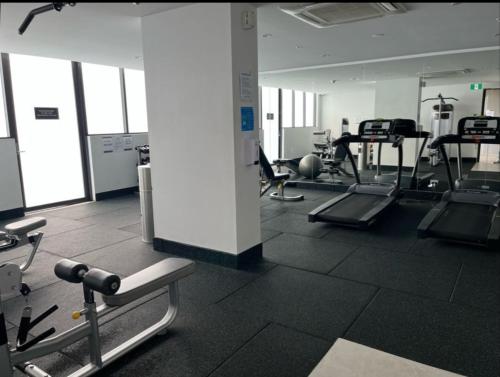 a gym with several treadmills and machines at Comfort Living - 3 Bedroom sleeps 6 , parking, pool, other amenities - Near Showgrounds, NO PARTIES in Sydney