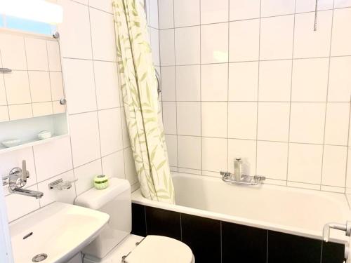 uma casa de banho com um WC, uma banheira e um lavatório. em City Apartment - close to town - by PA em Lucerna