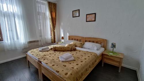 a bedroom with a bed with two pillows on it at Apartments Protin sokak in Sarajevo