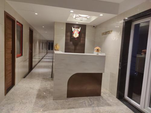 a hallway with a reception desk in a building at RR Mount Elite Suites in Chennai