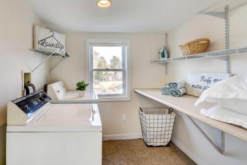 a kitchen with white shelves and a sink at Beautiful Common Fence Point Cottage By Beach in Portsmouth