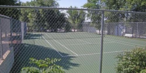 a tennis court with a net on a court at Gourgeous lake views, amazing susets, on main channel in Lake Ozark