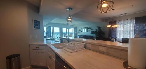 a kitchen with a counter with a sink in it at AMAZING LAKE VIEW! GORGEOUS SUNSET! ON MAIN CHANNEL! 3BR/2BA-SLEEPS 6-8 in Lake Ozark