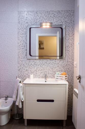 a bathroom with a white sink and a mirror at Casa Rural Los Eneares in Ossa de Montiel