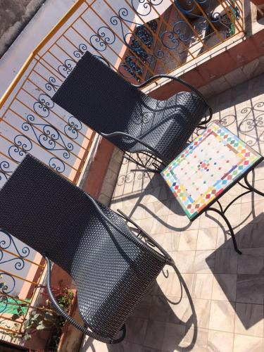 an overhead view of two black benches and a table at RIAD ESMERALDA By Dar Ouezzani in Rabat