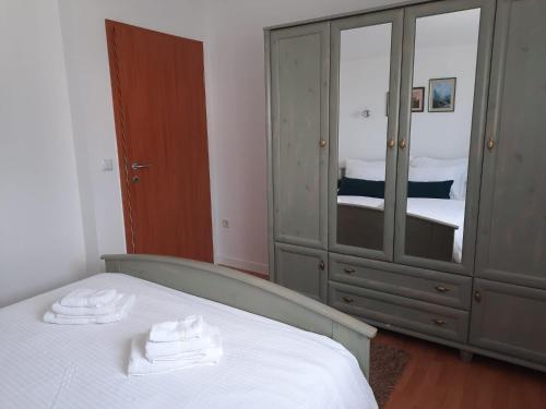 a bedroom with a bed and a dresser and a mirror at Residence Gordana in Selce