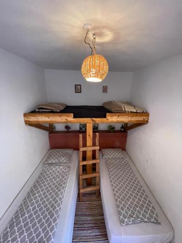 a small room with a bunk bed and a table at SALAS waveclimbing company in Sidi Ifni