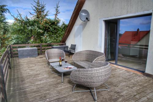 eine Terrasse mit Stühlen und einem Tisch auf einer Terrasse in der Unterkunft Ostseeferienhaus oberes Apartment in Mönkebude