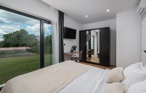 a bedroom with a bed and a large window at Villa Dual in Sveti Petar u Šumi