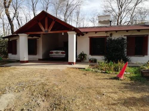 una casa con un coche aparcado en la entrada en Casa en el Bosque en 