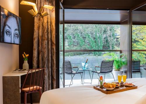 a bedroom with a bed and a view of a patio at Axel Hotel San Sebastián - Adults Only in Donostia-San Sebastián