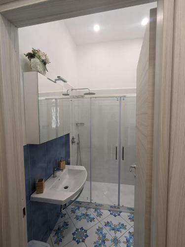 a bathroom with a shower and a white sink at Mamma Giovanna in Maiori