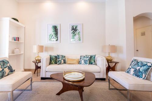 a living room with a couch and a table at Luxury Pool Villa with View Cabana BBQ 3minBeach in Tierra del Sol in Malmok