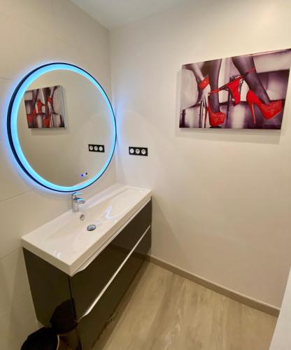 a bathroom with a mirror and a sink at La Vague Tendresse - Vue mer - Jacuzzi & Sauna in Le Tréport