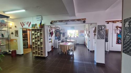 a room with a table and chairs in a store at Pensiune Runcu Stone in Runcu