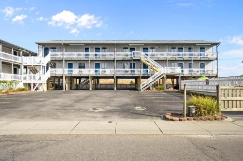 a large apartment building with a parking lot at The Beach House in Carolina Beach
