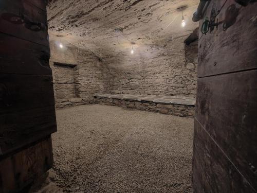a dark room with a stone wall and a bench at Rustico Mulino1 - Fully Renovated Near Locarno and Ascona in Minusio