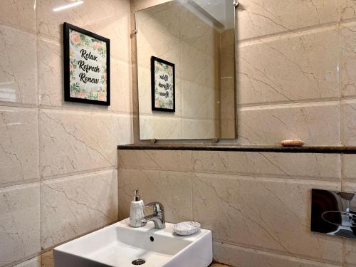 a bathroom with a sink and a mirror at Luxurious Nirvana Apartment 2BHK in Vagator