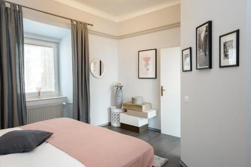 a bedroom with a pink bed and a window at Apartment Napoleon in Ljubljana