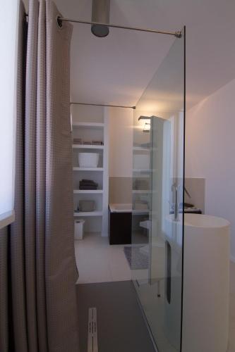 a bathroom with a glass shower and a sink at La Casa di Giò in Caorle