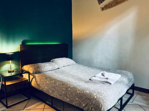 a bedroom with a bed and a green wall at Piazza Verdi Apartment in Bologna