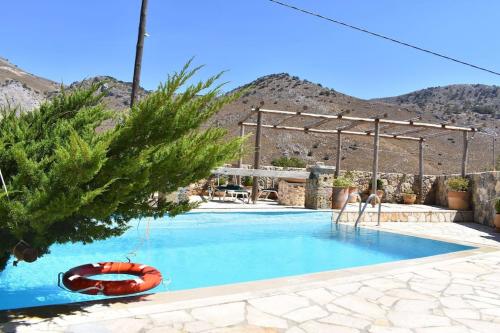 a swimming pool with a red raft in the middle at Traditional Villa with pool in Sfakia in Ímbros