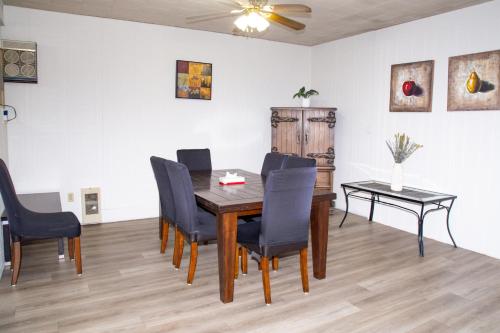 a dining room with a table and chairs at Spanish Villa Resort in Penticton