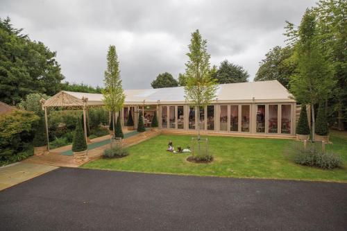 a house with people sitting on the grass in front of it at Hurley House Hotel in Hurley