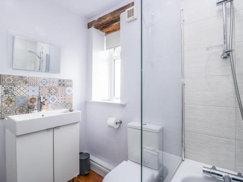 a bathroom with a toilet and a glass shower at Station View in Soutergate