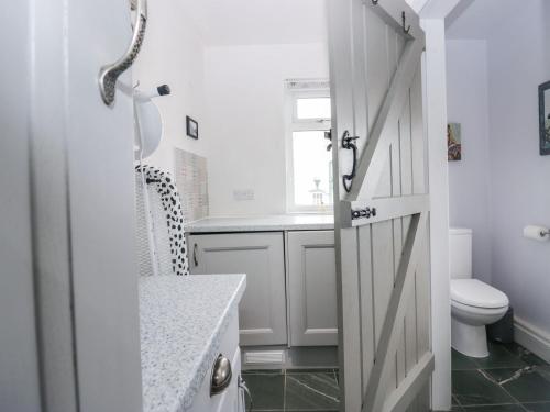 a bathroom with a door leading to a toilet at Station View in Soutergate