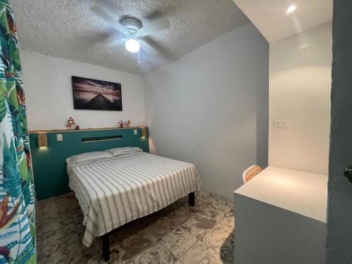 a small bedroom with a bed in a room at Nómadas Hostel in La Paz