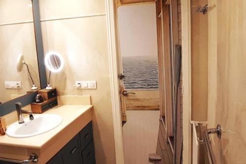 a bathroom with a sink and a view of the ocean at Vistas a la ria y garaje en el Castro, centro Vigo in Vigo