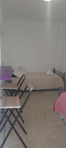 two folding chairs and a bed in a room at Coordenadas Ibiza in Ibiza Town