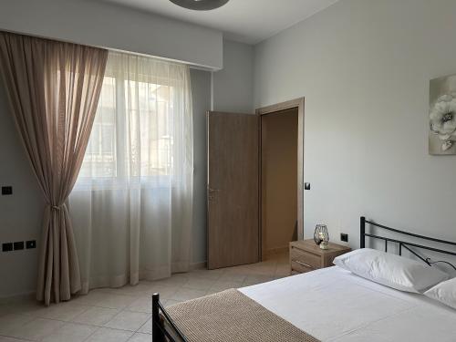 a bedroom with a bed and a window at Little Nest - Luxury Living in Kos Town