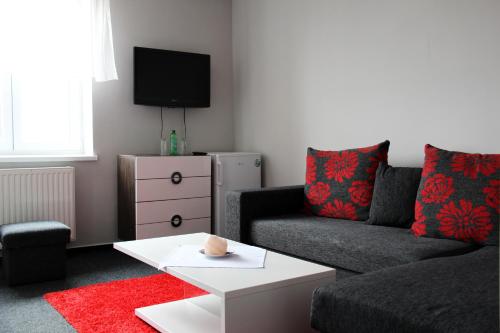a living room with a couch and a table at Hotel Sonata in Hradec nad Moravici