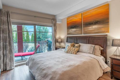a bedroom with a large bed and a window at Fabulous Condo at Five Star Resort 209 in West Kelowna